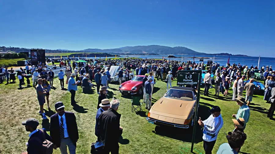 The show field at the Pebble Beach Concours d'Elegance, cars and crowds under a clear sky