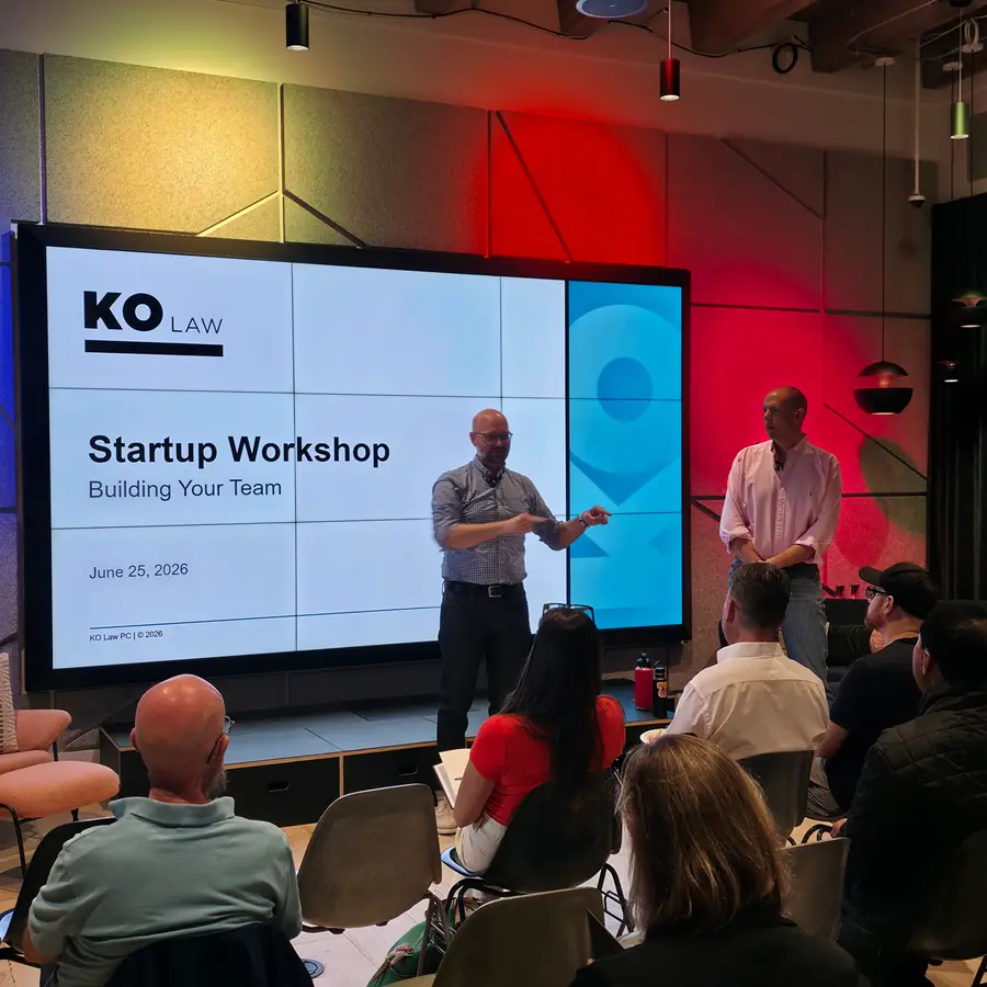Two presenters lead a KO Law startup workshop in front of a seated audience