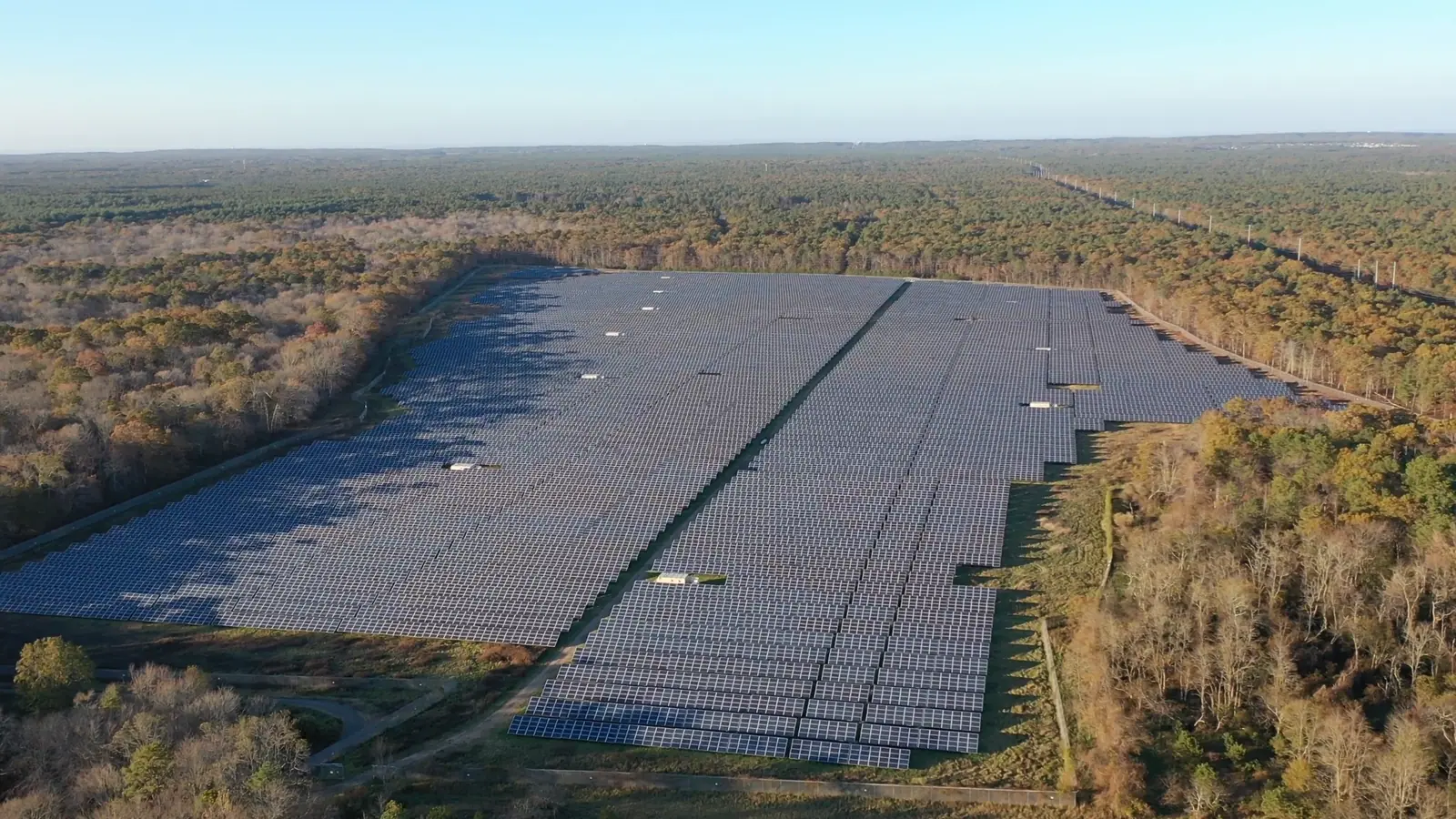 Aerial of a large solar array in a green landscape, from the Hero X Solar film